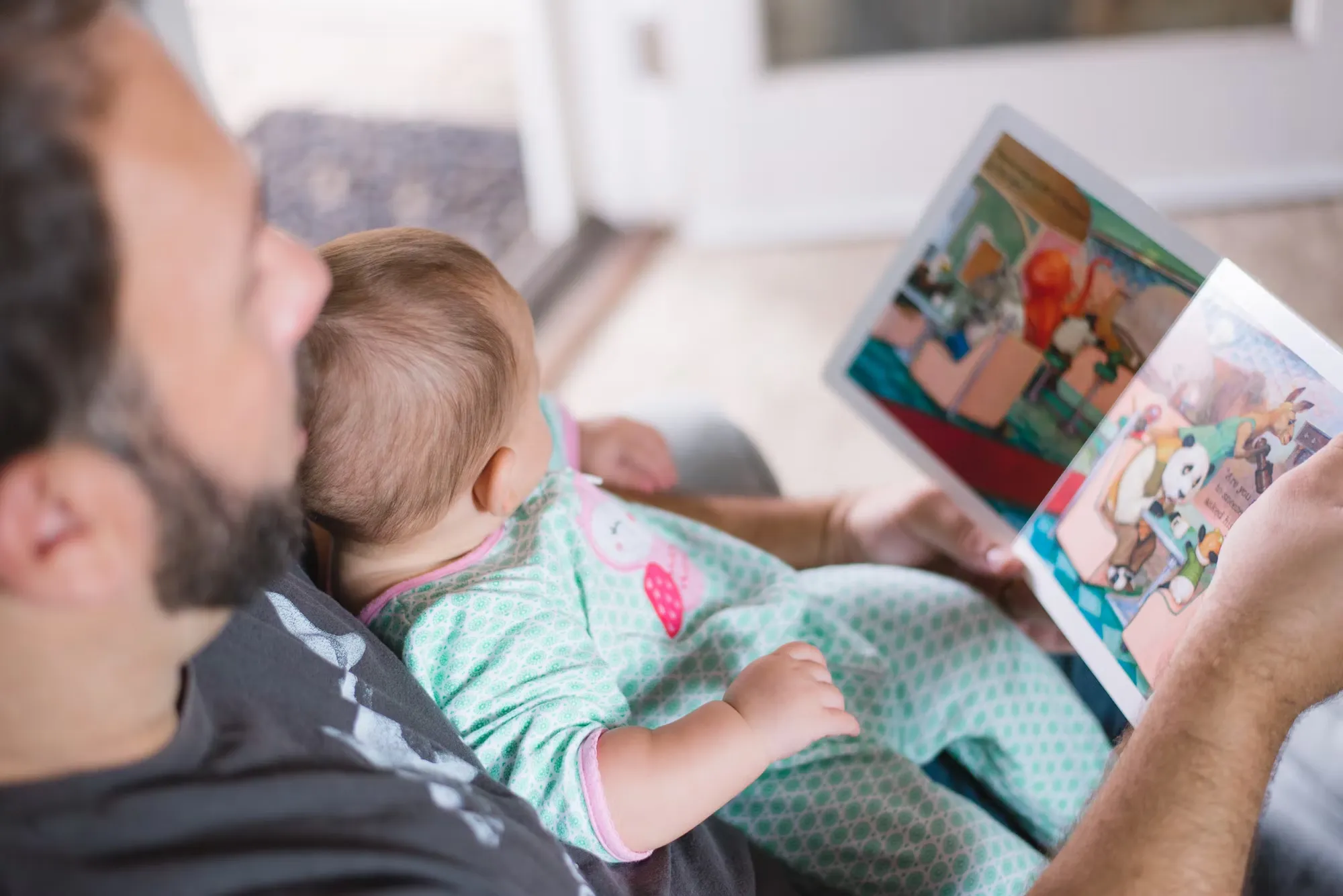 

An image of a young girl snuggled up in bed with a stack of books beside her. She is happily reading one of the books, with a smile on her face. The image conveys the idea of a cozy and enjoyable bed